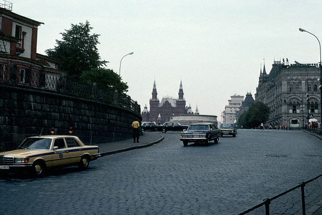 1983, Moscow, USSR --- A parade of official cars exit the Kremlin around the base of St. Basil's Cathedral. Ordinary citizens are not allowed to drive in this square. --- Image by © Dean Conger/CORBIS