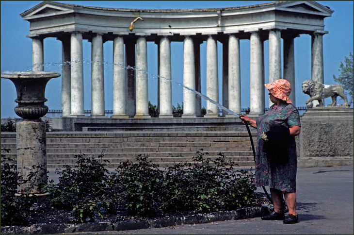 Ukraine. Odessa. A woman gardener spraying with a hosepipe in front of the colonnades of Count Vorontson's Palace. 1982