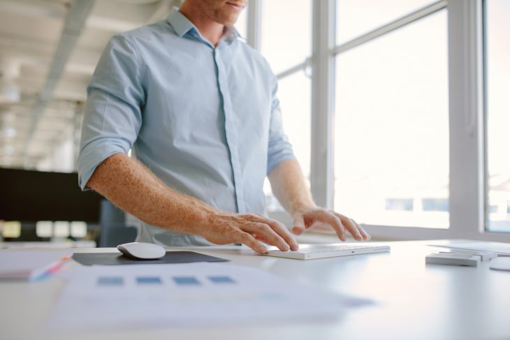 Young man at his desk working on computer