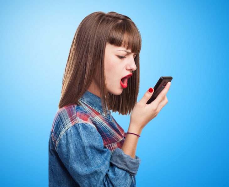 portrait of worried young girl talking on mobile phone